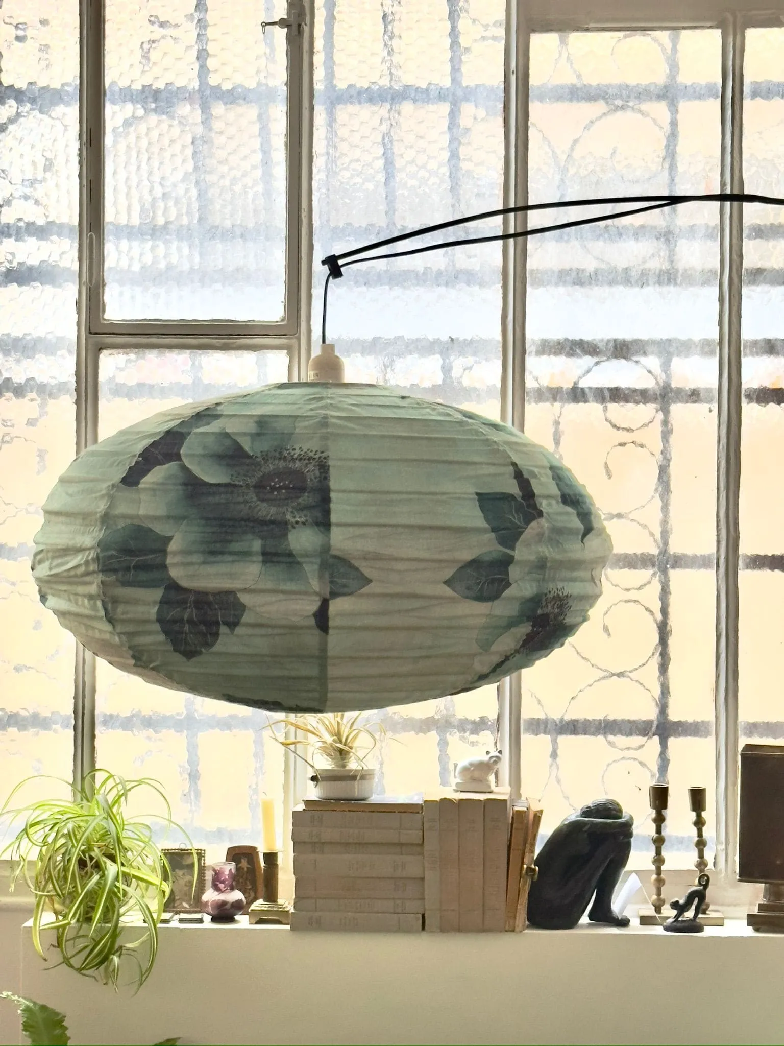 suspension sofa blue and green canvas and wallpaper in showroom decoration Paris Belleville