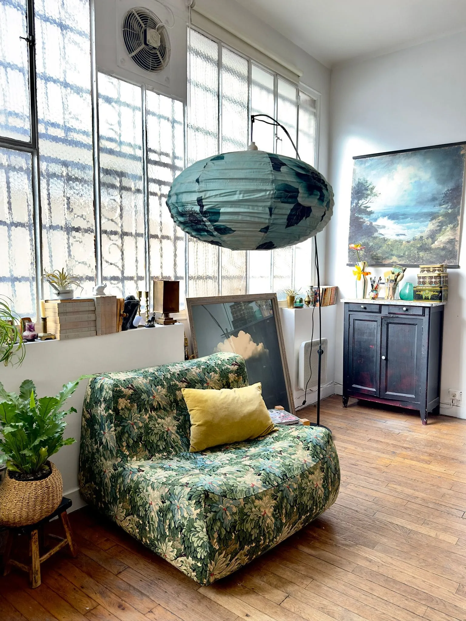 suspension sofa blue and green canvas and wallpaper in showroom decoration Paris Belleville